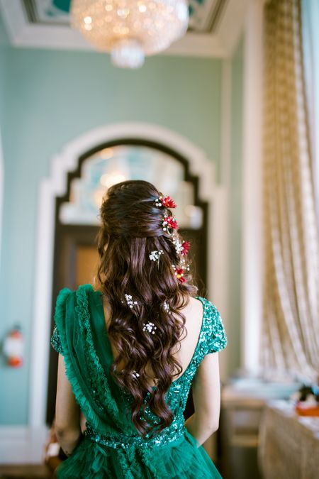 A bride flaunting her beachy waves hairstyle with flower clip ons