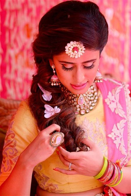mehendi bridal look with hairstyle with flowers