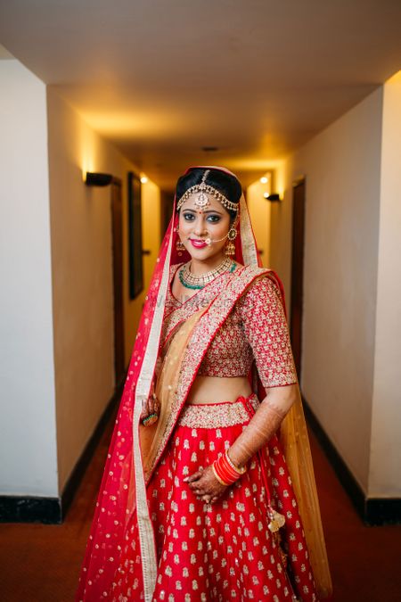 Photo of Red and Gold Lehenga with Gold Jewelry
