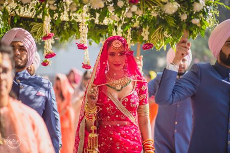 Photo of Bride entering with brothers under phoolon ki chadar.