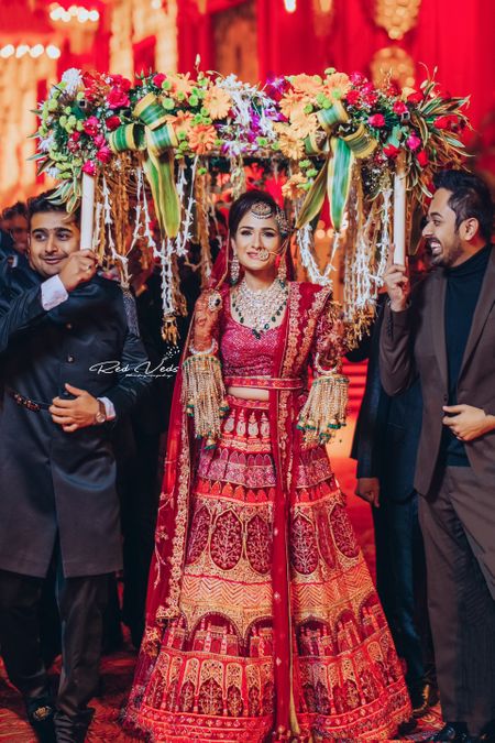 Photo of bridal entry in unique lehenga and phoolon ki chadar