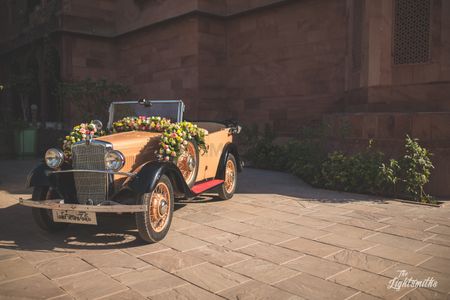 A vintage car decorated with flowers. 