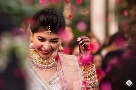 Photo of happy bride shot during day wedding in pink