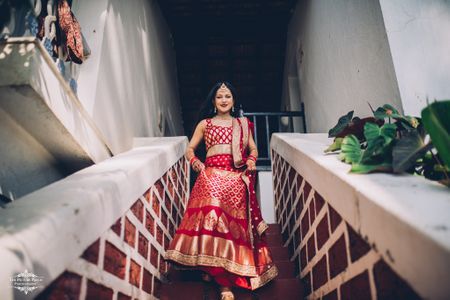 Photo of A beautiful bridal shot in red silk lehenga.
