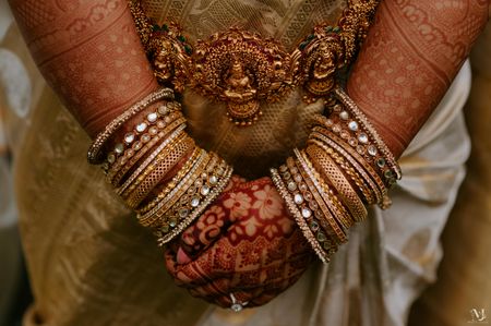 A shot of beautiful gold waistbelt and bridal bangles.