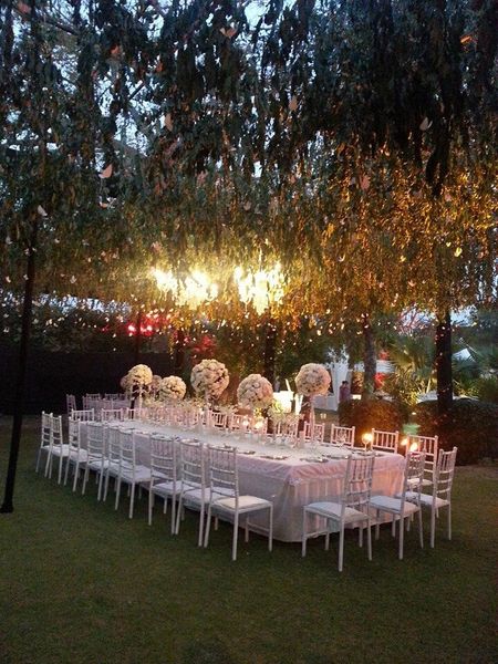 White Table Decor with Hanging Lights and Floral Decor