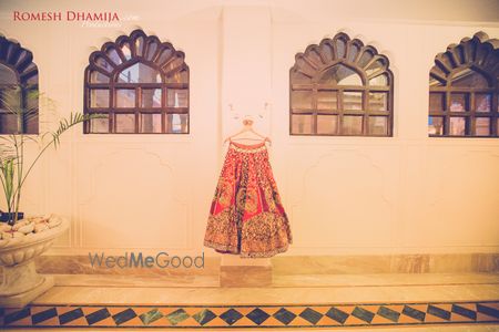 Orange and Gold Wedding Lehenga on a Hanger