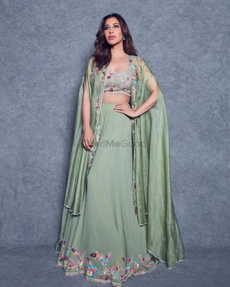 This light green lehenga with cape style dupatta fits well for a pooja ceremony.