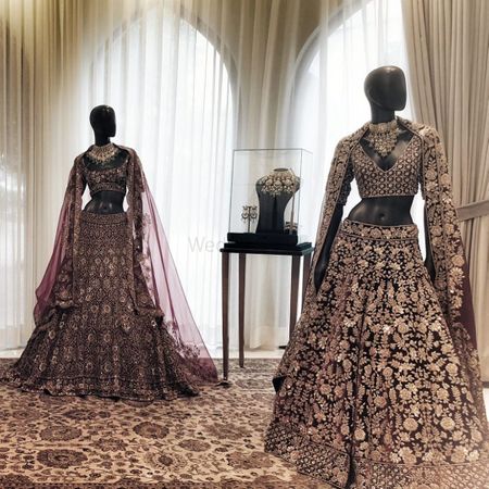 Maroon & gold and Plum & gold heavy bridal lehengas with detailed blouse and net dupatta.