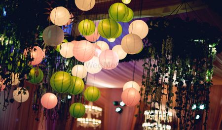 Hanging lanterns green apply and blush pink for indoor banquet decor