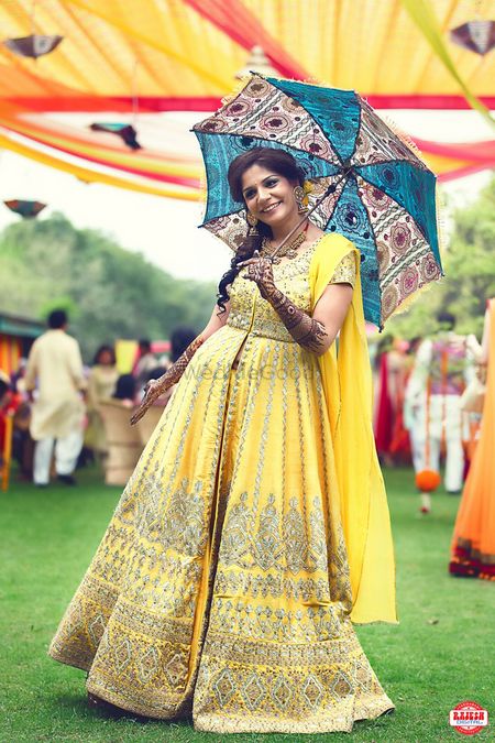 Photo of Light Yellow and Gold Anarkali Bride with Umbrella