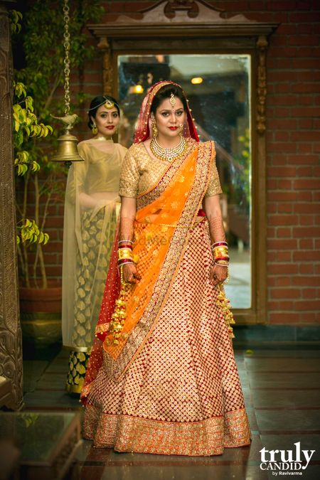 Red and gold bridal lehenga with yellow dupatta