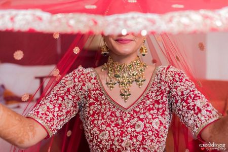 A beautiful veil shot of a bride dressed in red.