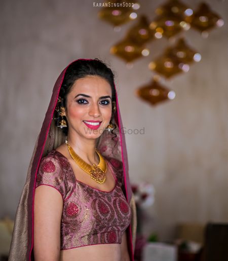 Bride wearing Gold Jewelry and Pink Lehenga