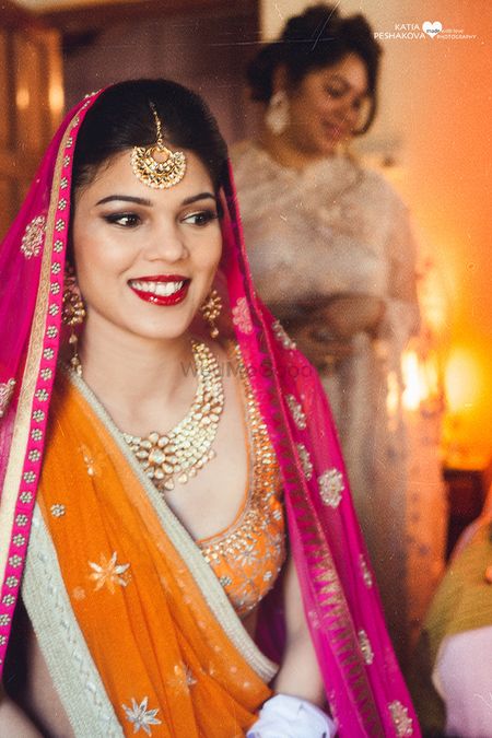 Bride in Orange and Pink Dupatta