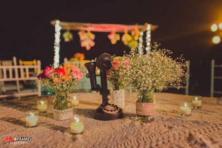 Photo of Dim Candles Table Decor with Floral Centerpiece