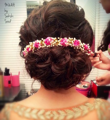 Broad bun with floral hair accessory
