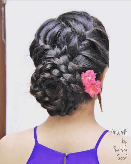 Braided bun hairstyle with pink flowers