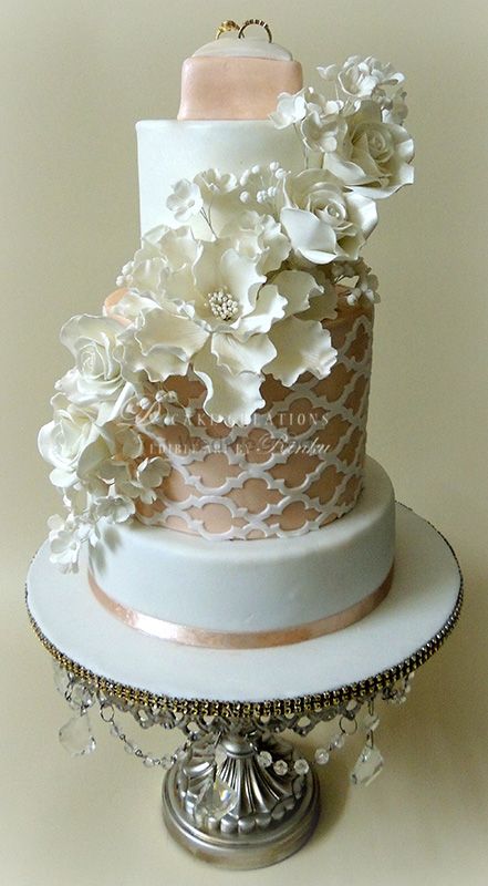 white and floral and peach wedding cake