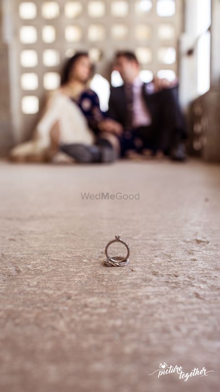 Engagement Rings in Focus with Couple Out of Focus
