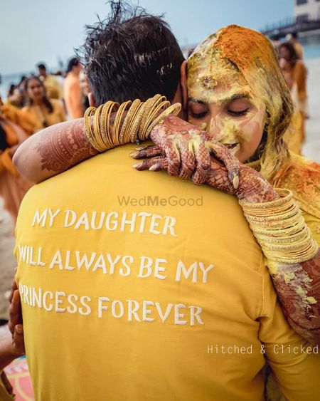 Photo of An emotional moment between the bride and her father on her haldi day.