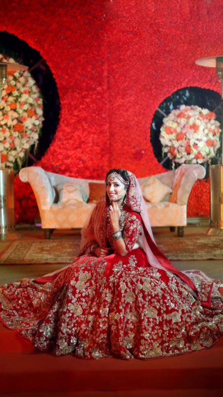 Red and gold bridal lehenga with white dupatta