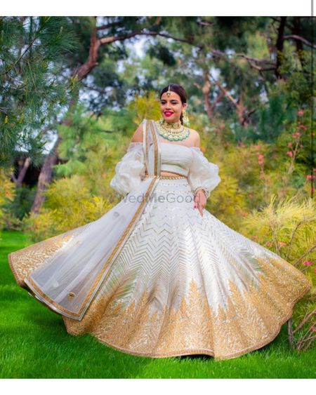 Photo of Bride in a white and golden lehenga