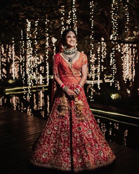 Photo of A beautiful orange and red bridal outfit by Tarun Tahiliani