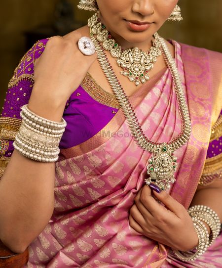 A pair of silver necklaces and silver kadas for south Indian brides.