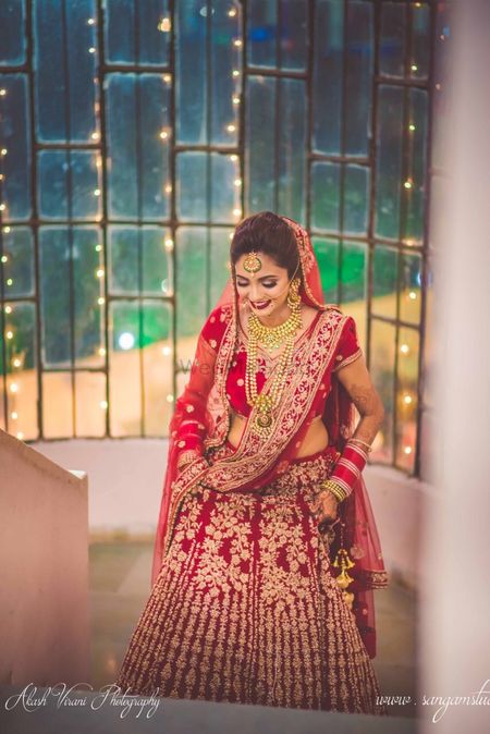 Bride entering in red and gold lehenga 