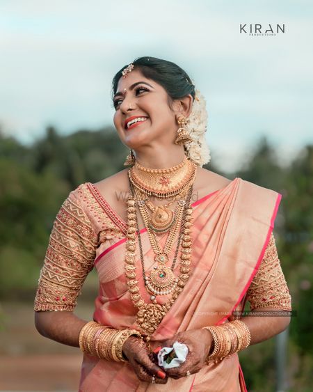 South Indian bride dressed in pink saree on her wedding day