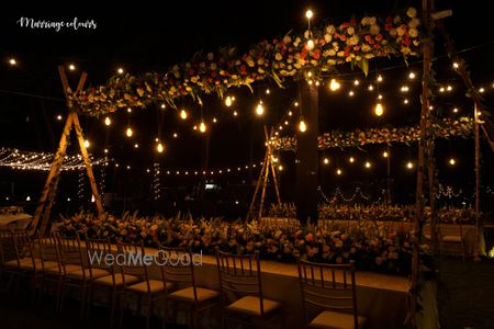 Gorgeous decor with flowers and fairylights for a sit down dinner 