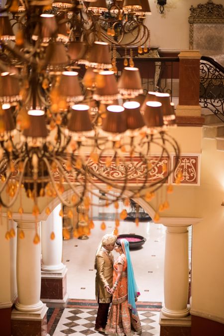 Couple portrait under chandelier