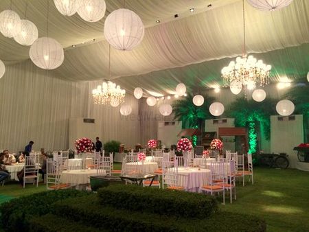 white draped ceiling with hanging lanterns