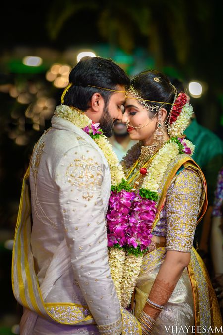 South Indian couple in colour-coordinated outfits on their wedding day