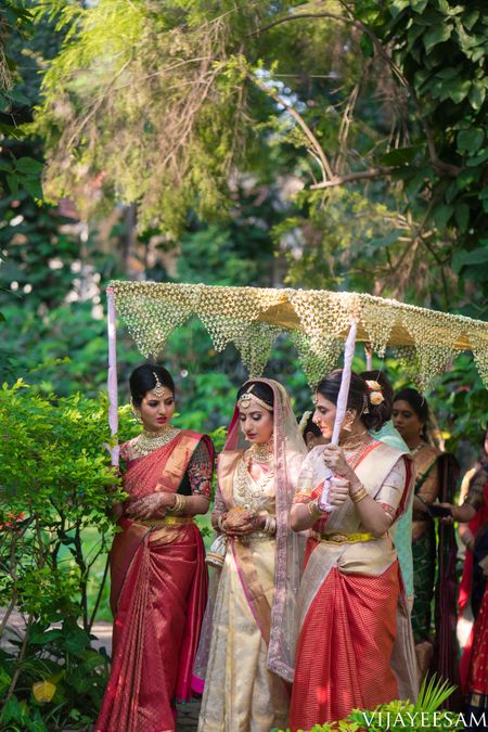 South Indian Bridal Entry under a phoolon ki chaadar with bridesmaids.