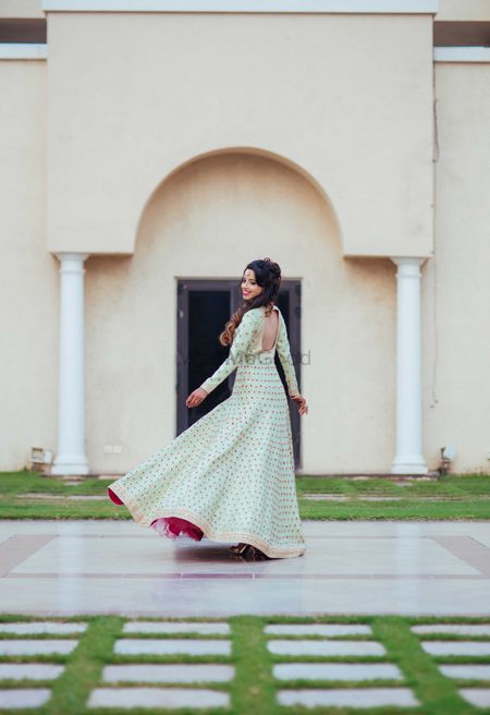 Photo of Twirling Bride Wearing Mint and Pink Anarkali