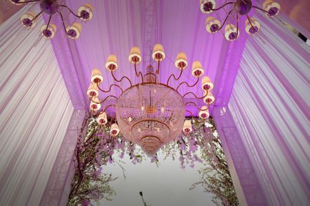 Photo of Pink Tent Decor with Hanging Chandeliers