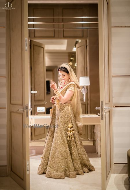 Bridal portrait with bride in gold lehenga