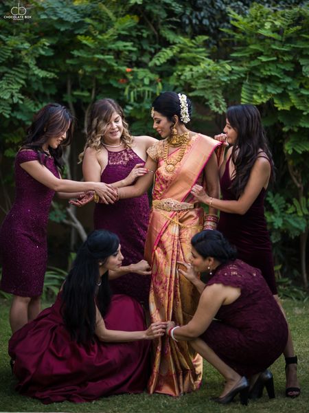 Bridesmaids helping bride get ready South Indian wedding 