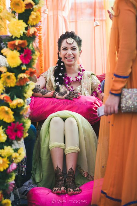 Bride Getting Mehendi Put Wearing Floral Jewellery