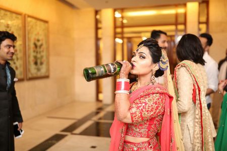 Bride in Red Posing with Whiskey Bottle
