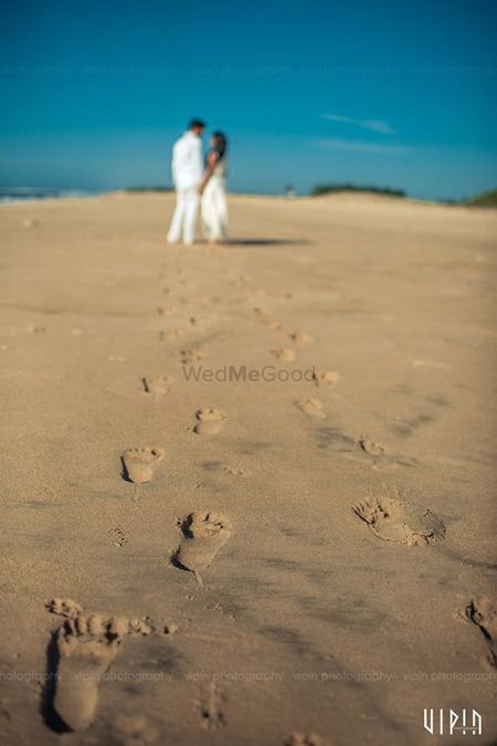 Beach Wedding Couple Portrait with Sand Footprints