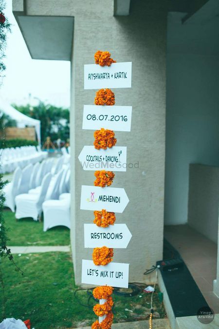 White direction boards with genda phool