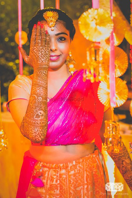 Bride showing off mehendi with quirky mehendi decor