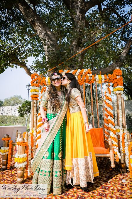 Photo of Bride and Sister Fun Photo at Outdoor Mehendi
