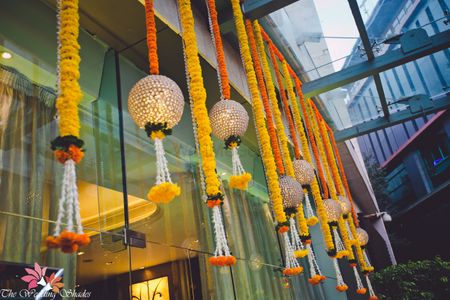 Photo of Genda Phool Strings Hung with Round Lamps