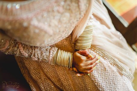 Photo of bridal hands with simple white bangles