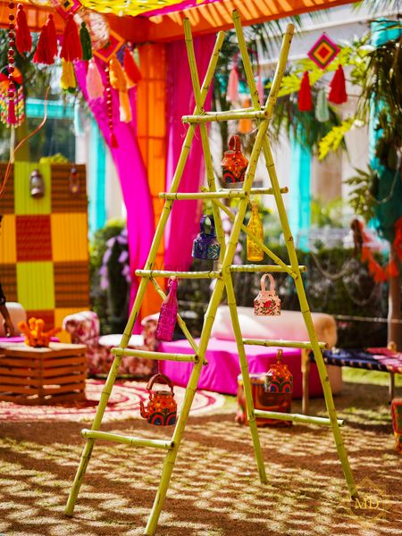 Ladder decorated with kettles, glass bottles and more for mehndi photobooth