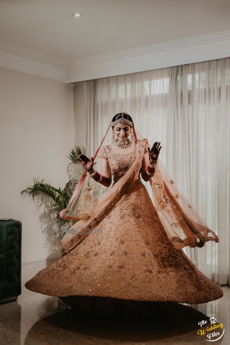 Bride twirling in a beautiful pastel lehenga. 